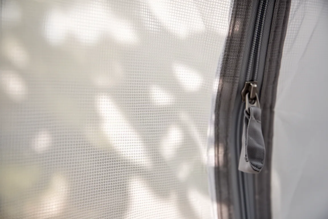 Close-up of fine nylon mesh tent panel with light passing through the weave