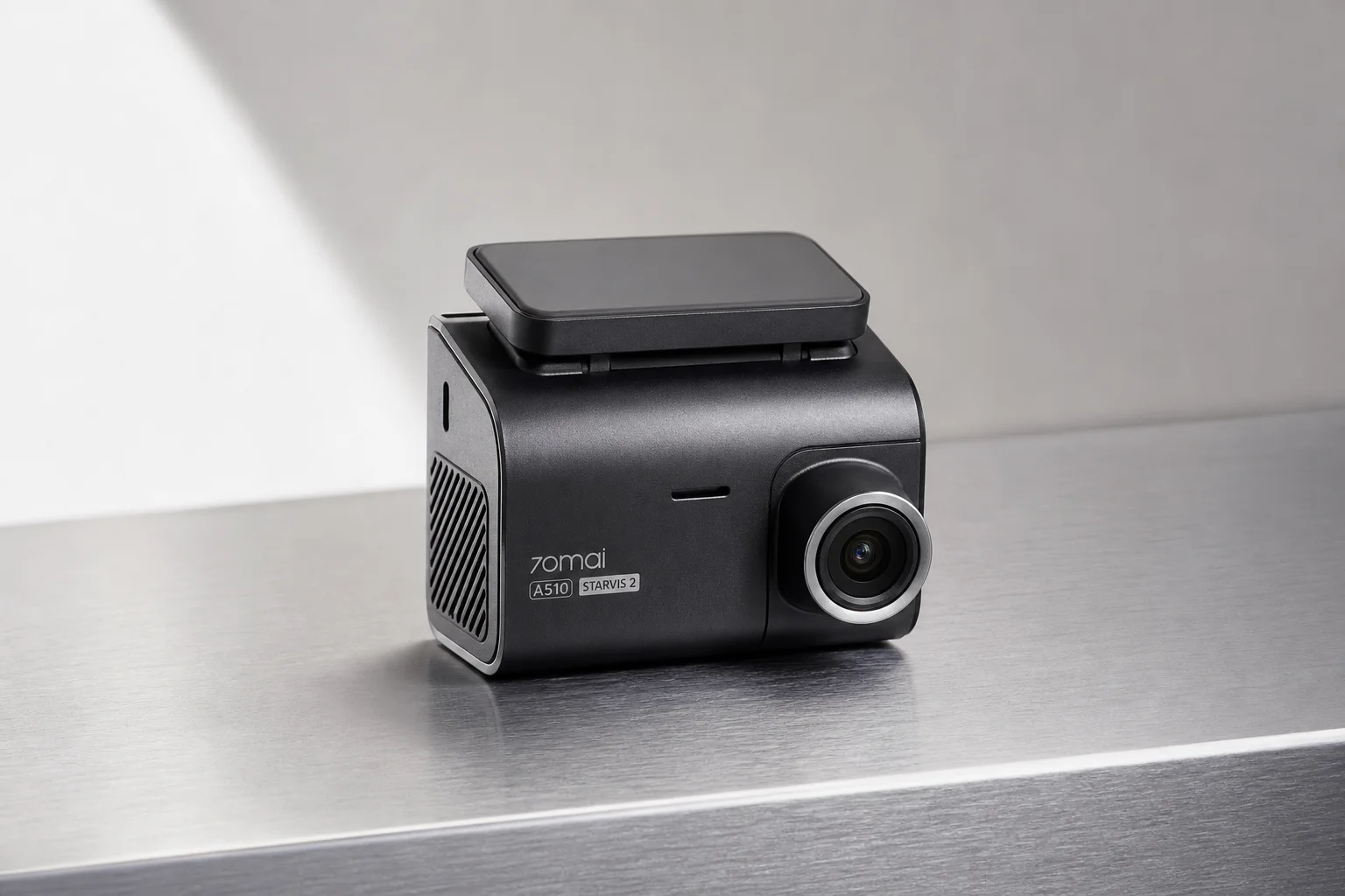 Three 70mai dash cameras A200, A510, and A810 arranged by size on grey surface