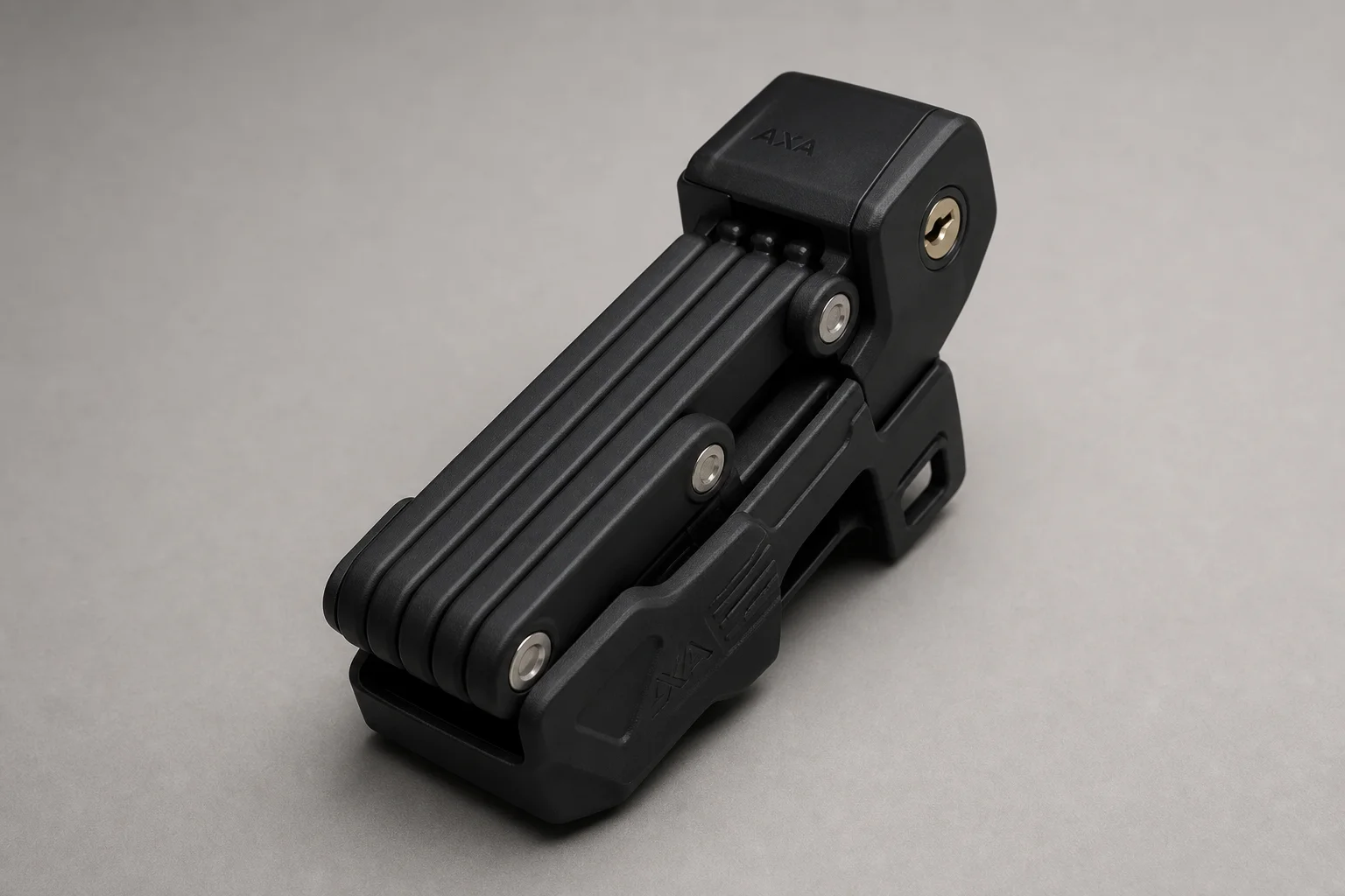 Three Abus bike locks arranged on neutral backdrop: folding lock, U-lock, and heavy-duty lock