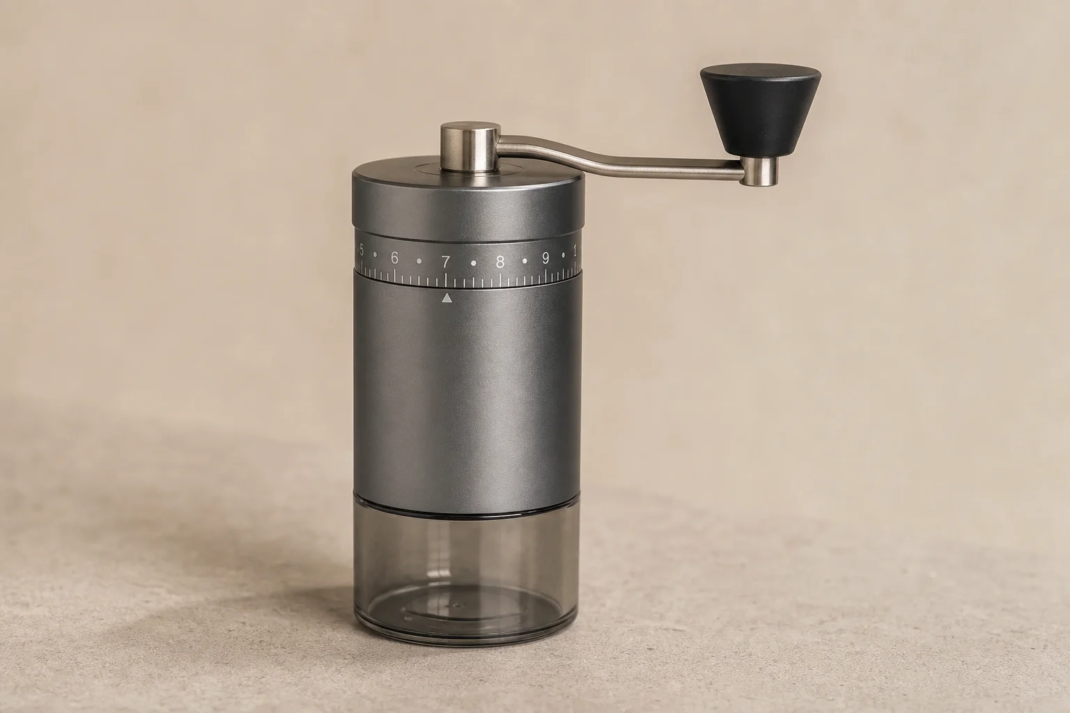 Seven premium hand coffee grinders arranged on concrete surface