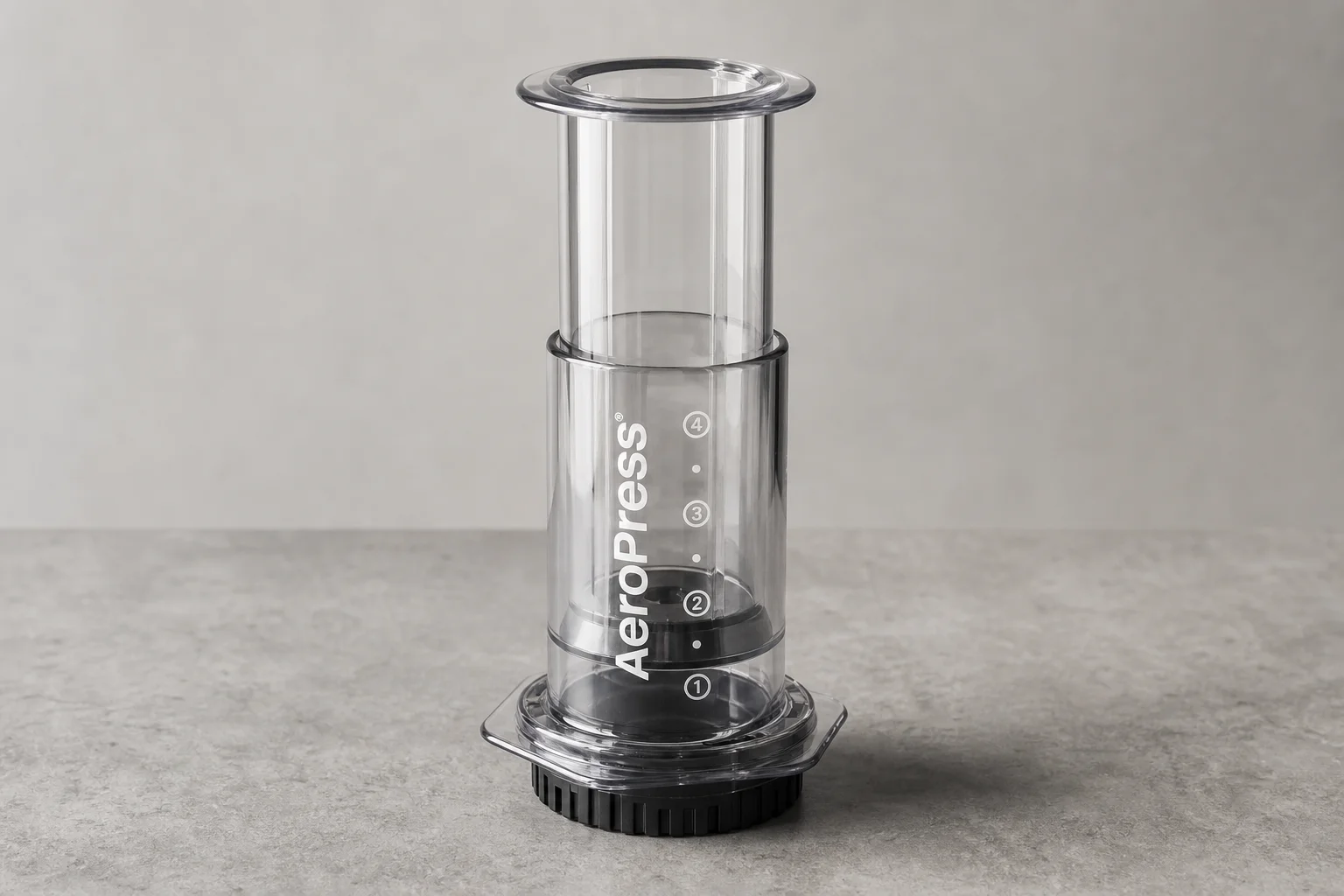 AeroPress Clear transparent coffee maker on concrete surface