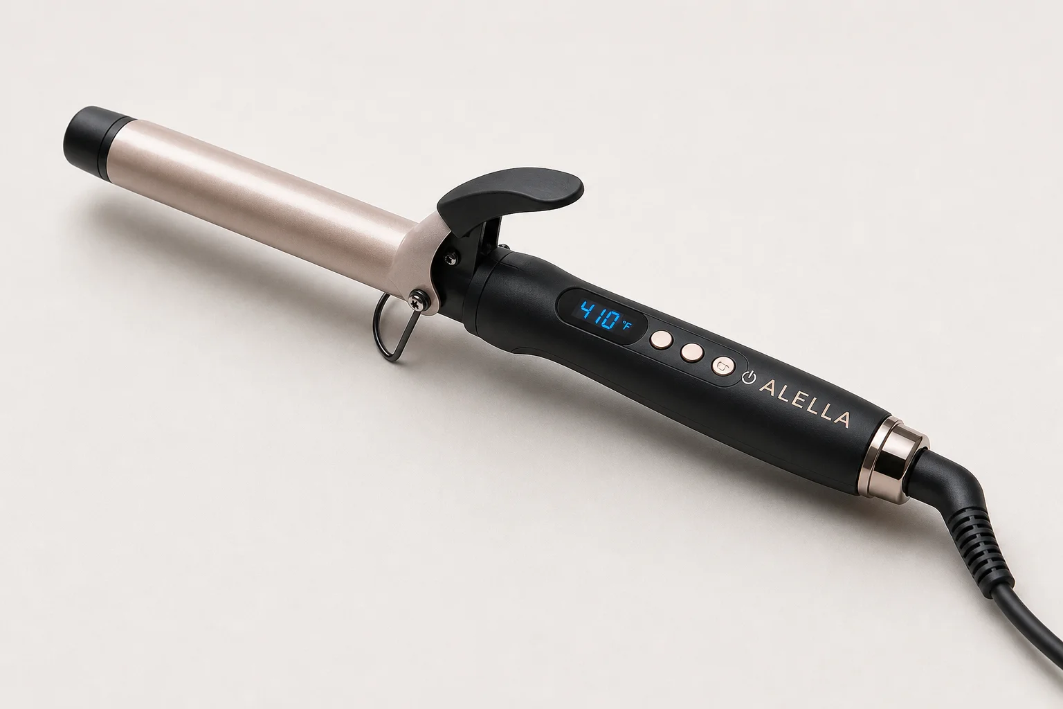 Five curling irons in various sizes arranged on a marble surface