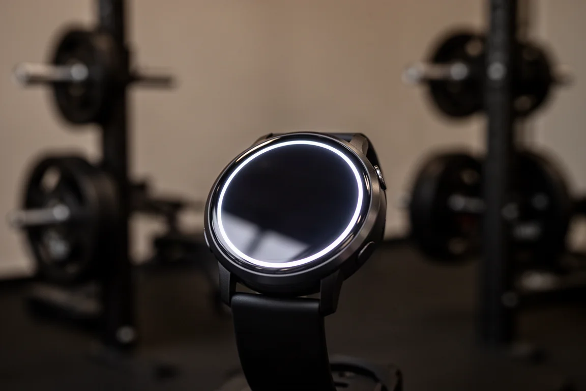 Bright watch display glowing in dim indoor gym lighting