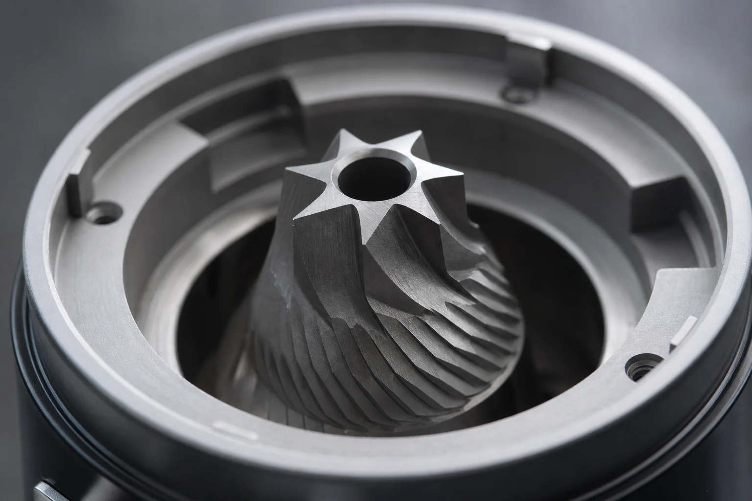 Close-up of 40mm conical burr with six cutting edges inside grinder chamber