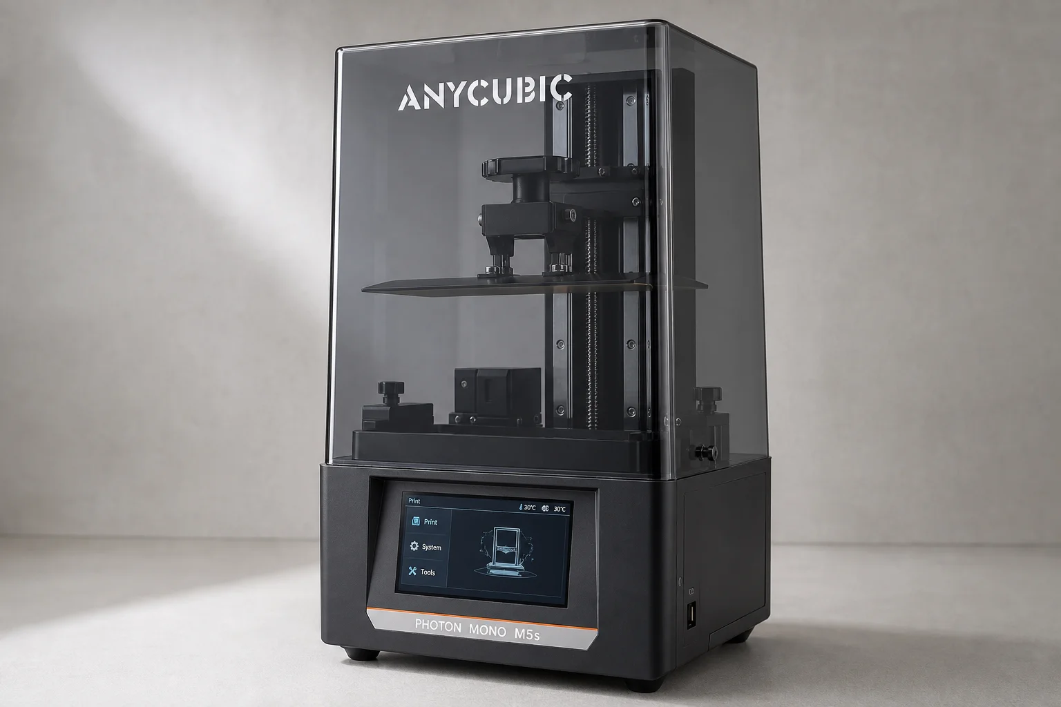Five resin 3D printers displayed on concrete surface showing various sizes and designs