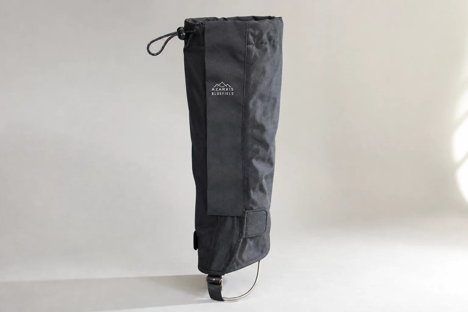 Five leg gaiters in different styles and materials arranged on concrete