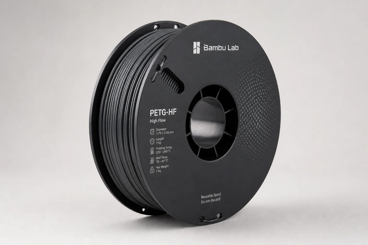 Collection of 3D printer filament spools on concrete surface including PLA, PETG, and specialty materials