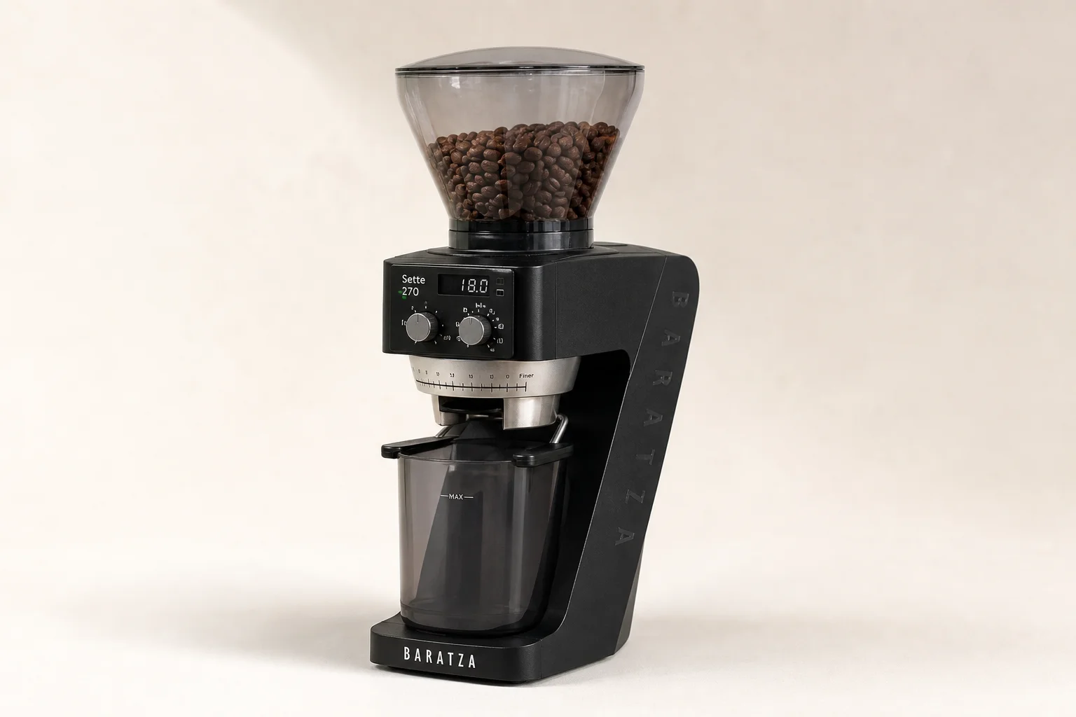 Seven espresso grinders of various sizes and styles arranged on concrete surface