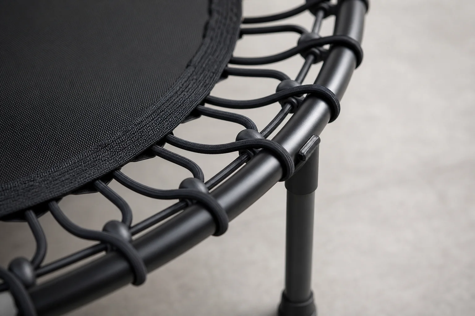 Close-up of bungee cord suspension system on mini trampoline frame