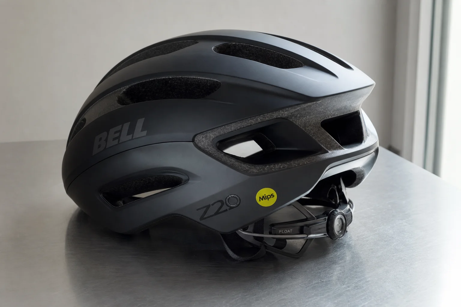 Five road bike helmets arranged in a row on concrete surface showing different designs