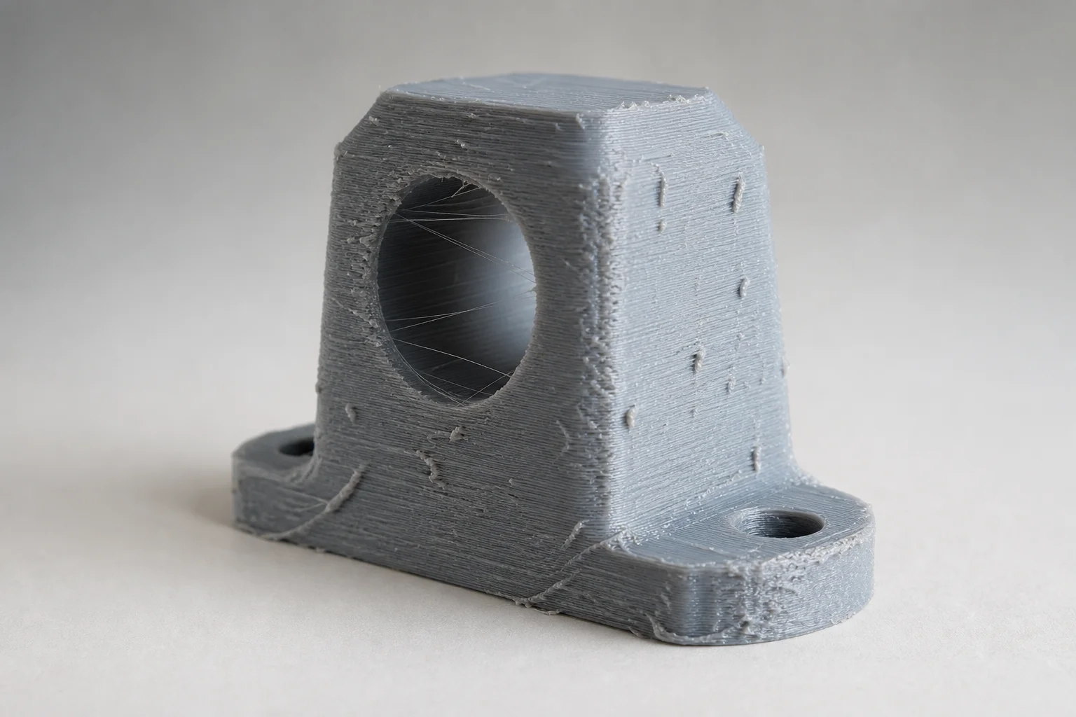 Failed 3D print showing stringing and surface defects from improper storage