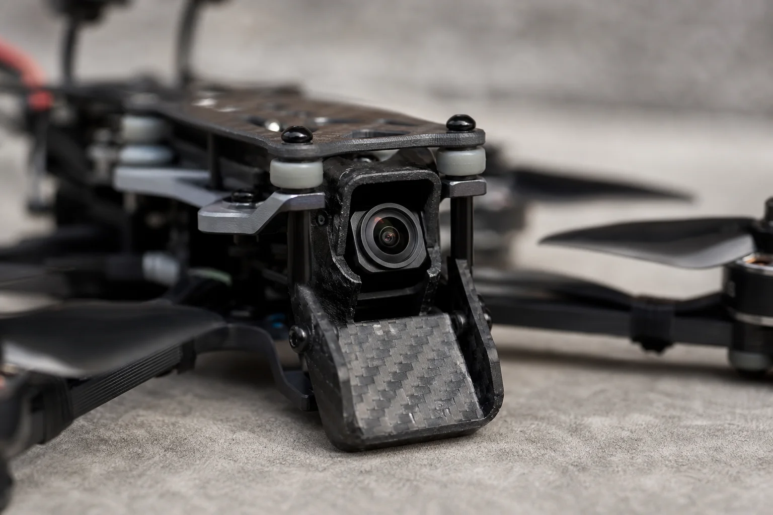 Close-up of FPV drone camera mount with DJI O4 Pro and protective chin guard