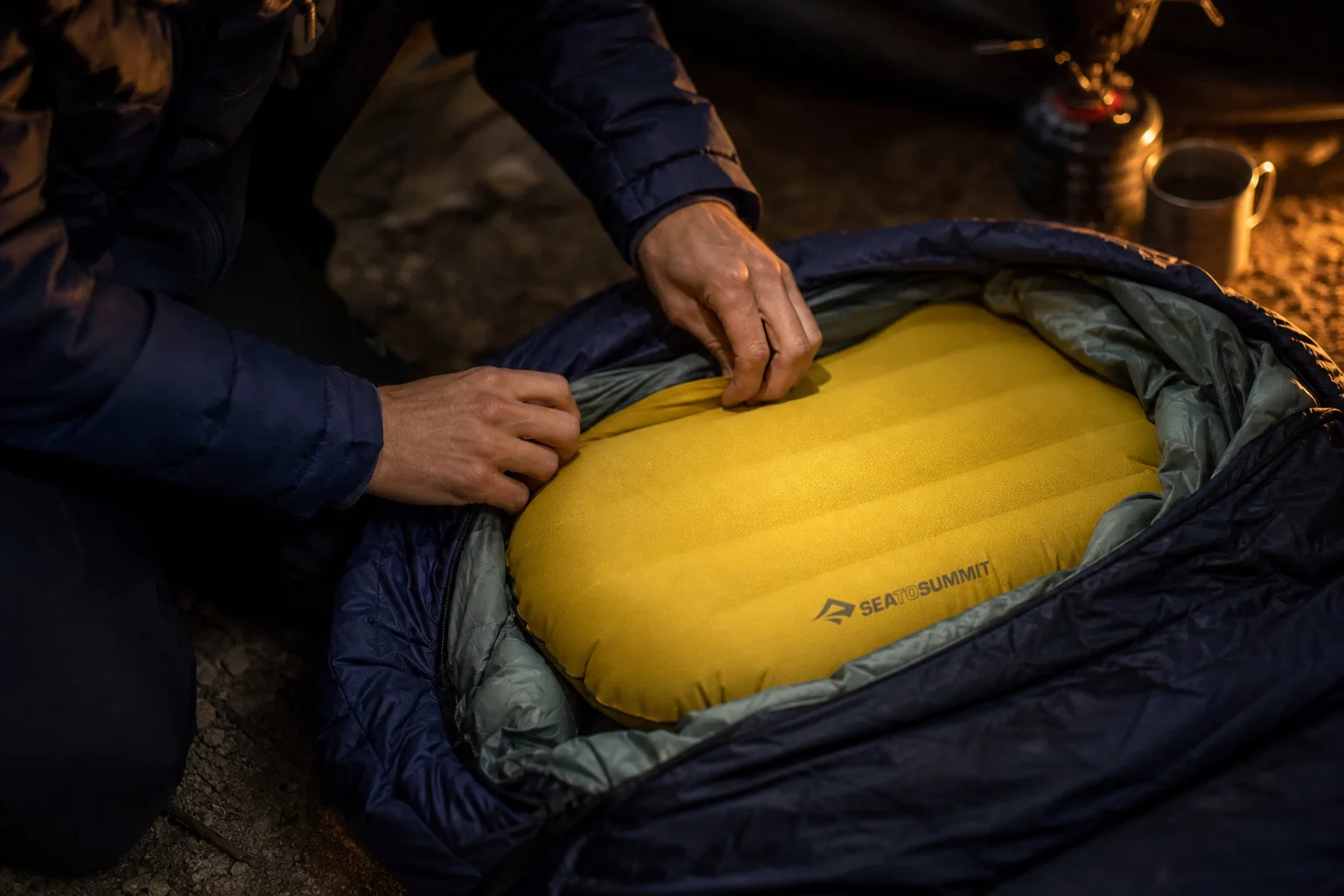 Backpacker passt ein aufblasbares Kissen im Schlafsack an