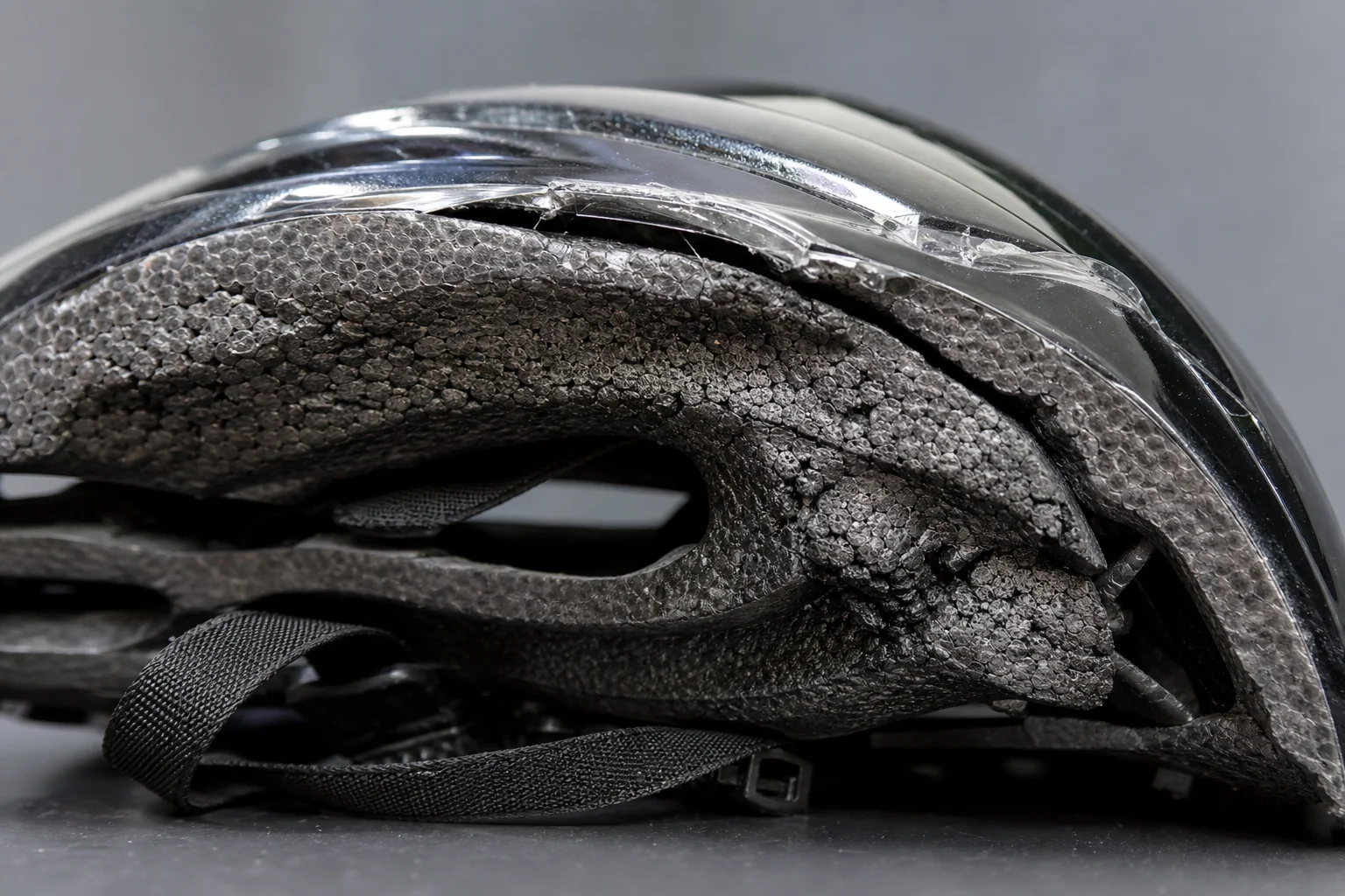 Close-up of helmet foam deformation and impact damage from testing
