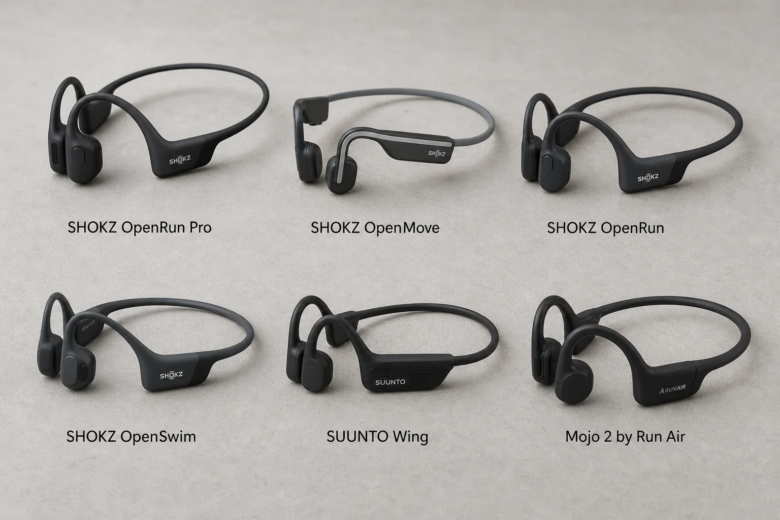 Seis auriculares de conducción ósea dispuestos sobre una superficie de hormigón mostrando diferentes modelos y diseños