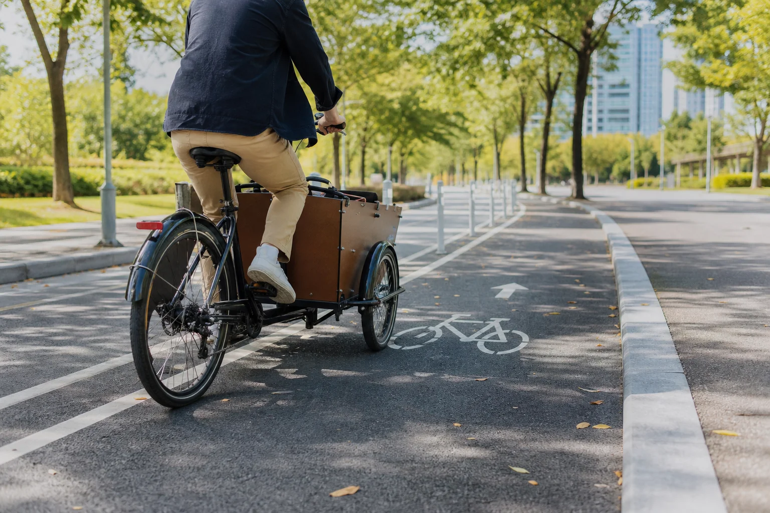 Cargo bike on protected bike lane in urban park with clear markings