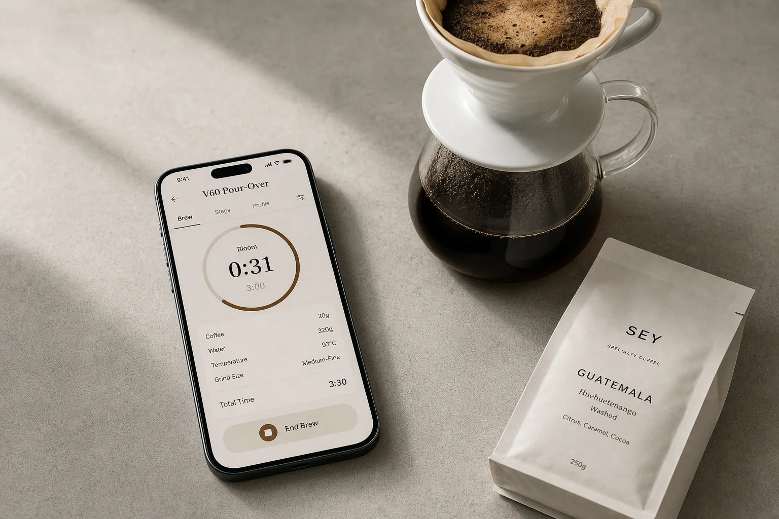 Smartphone with coffee app displayed next to pour-over dripper and coffee beans on concrete