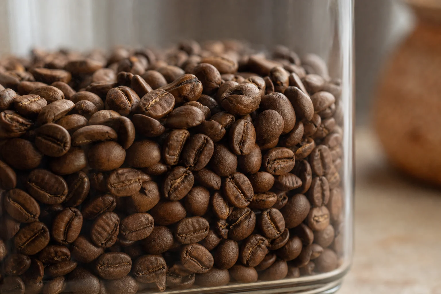 Close-up of coffee beans inside a glass storage container