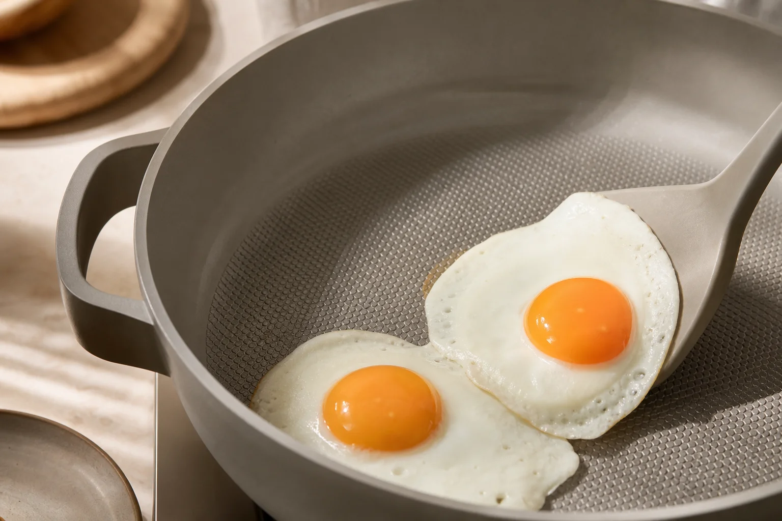 Our Place Always Pan Pro cooking eggs with visible non-stick release