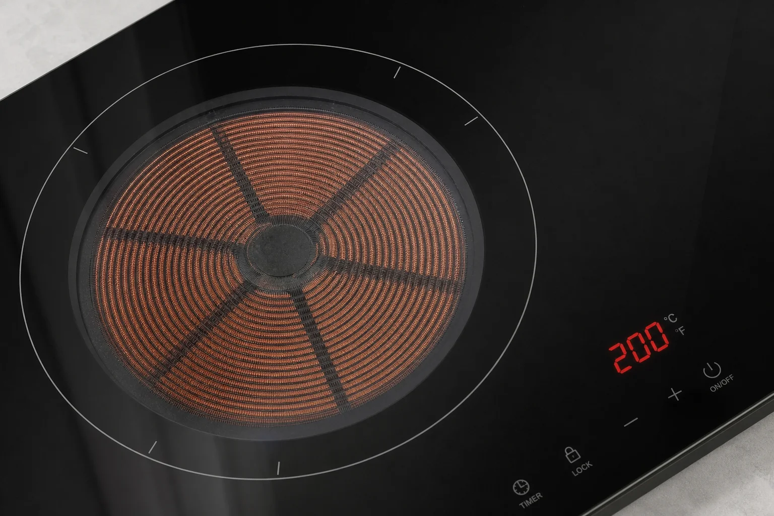 Fry pan sitting on an induction cooktop burner with gentle steam rising