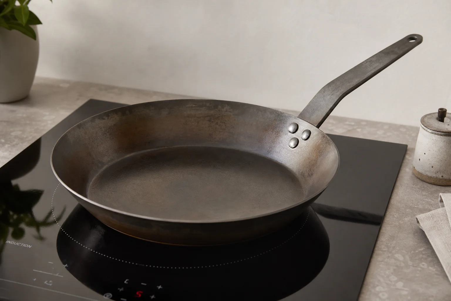 Cooktop burner glowing with a heavy pan centered on the coil
