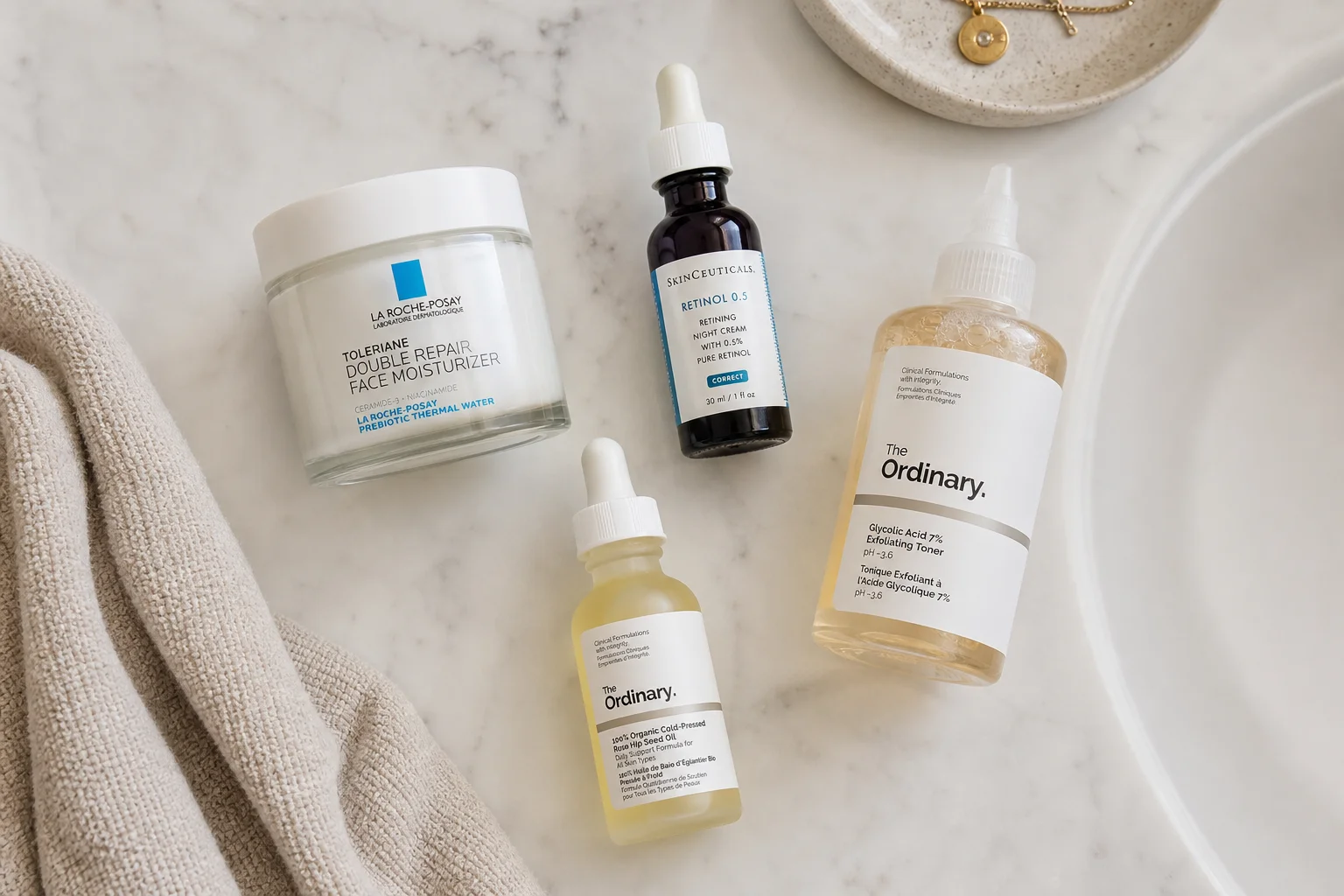Skincare products including moisturizer, retinol, and exfoliator on bathroom counter