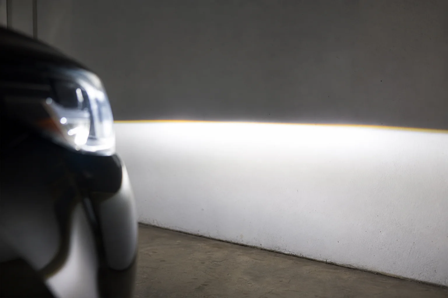 Jeep headlight beam pattern on garage wall with crisp cutoff line