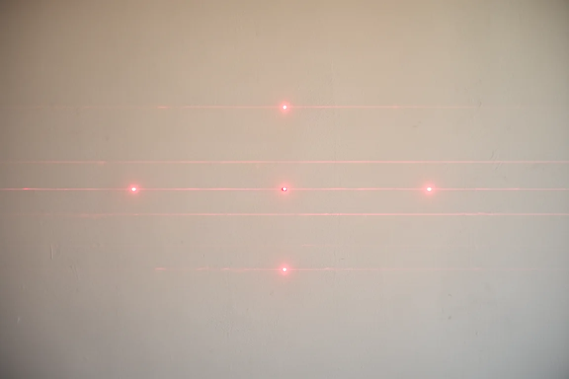 Laser measure dots from different devices aligned on a wall