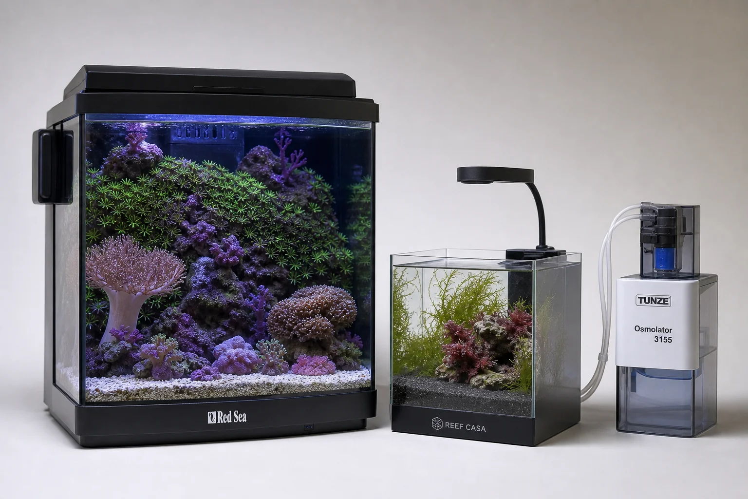 Three nano reef aquarium systems and automation equipment displayed together