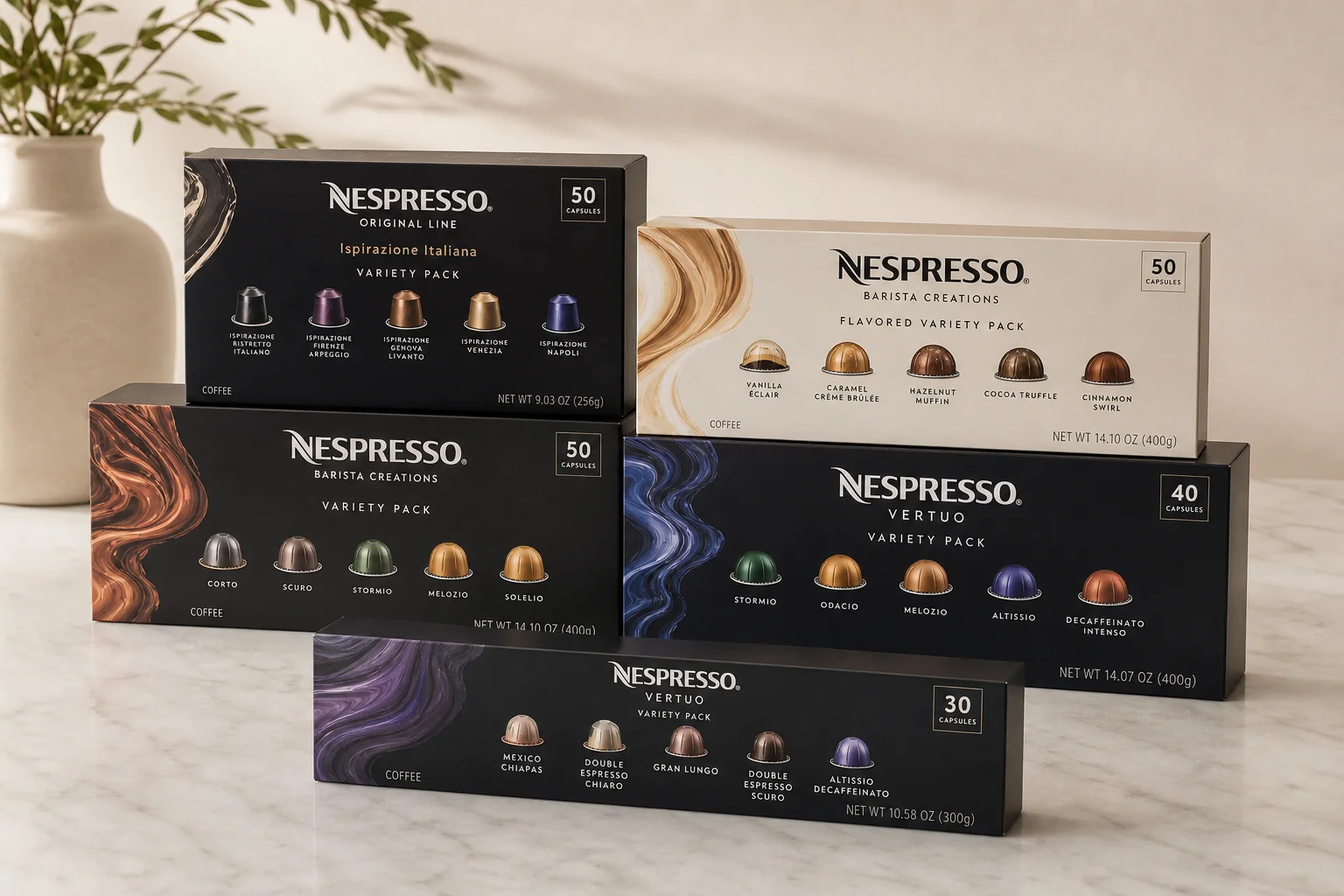 Five Nespresso capsule variety packs displayed on marble surface