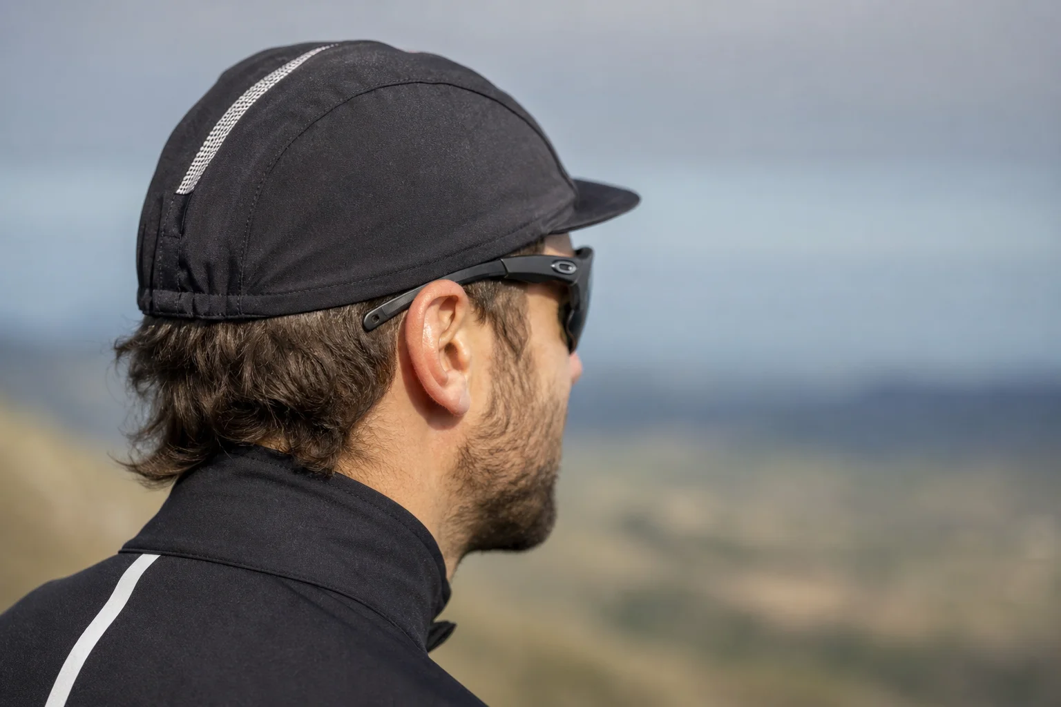 Cyclist wearing cycling cap and sport sunglasses showing frame and hat fit