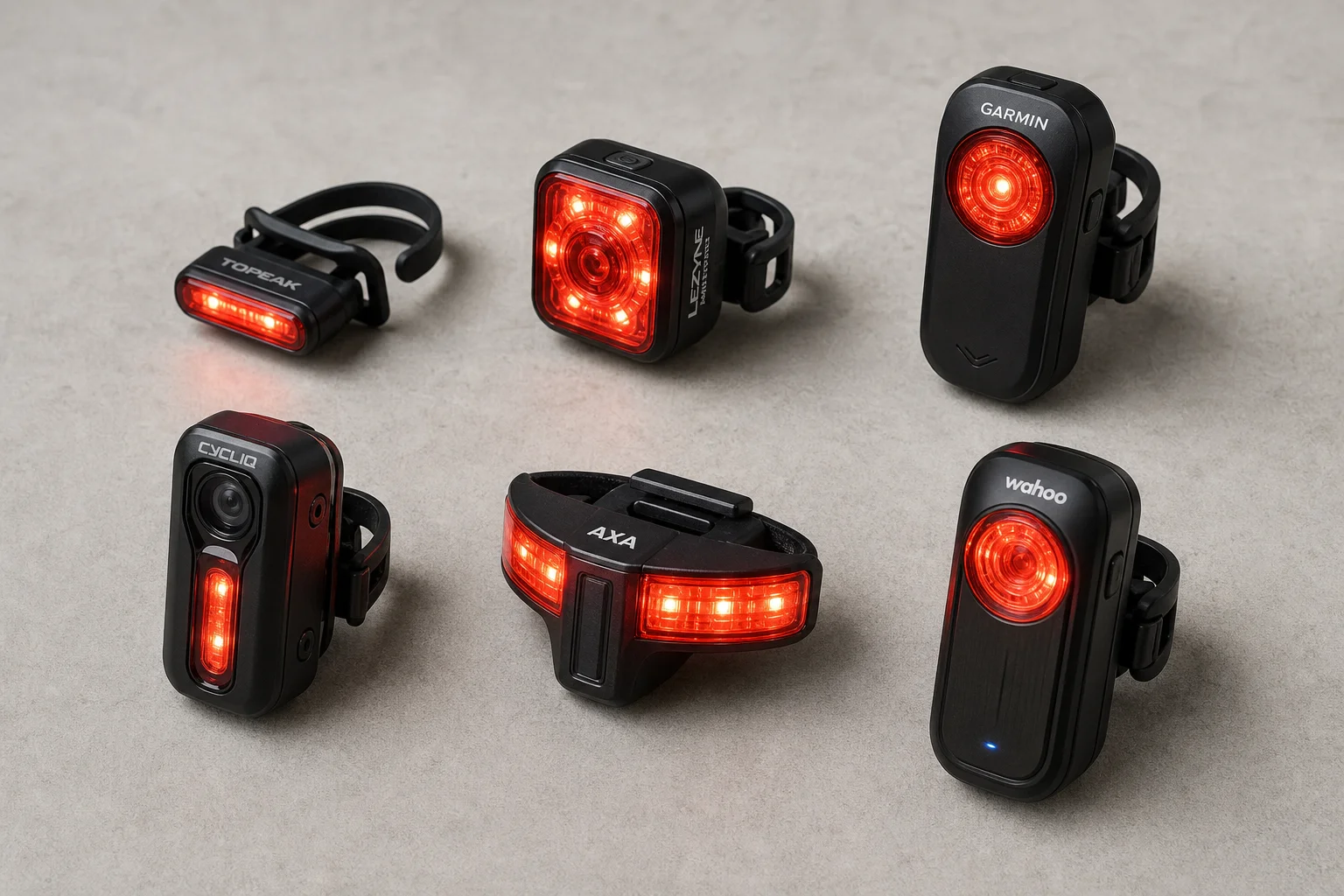 Six rear bike lights arranged on concrete surface