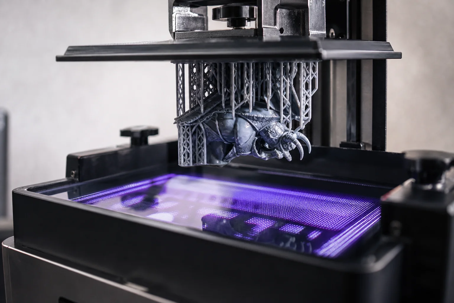 Close-up of resin printer LCD screen displaying detailed miniature model layers