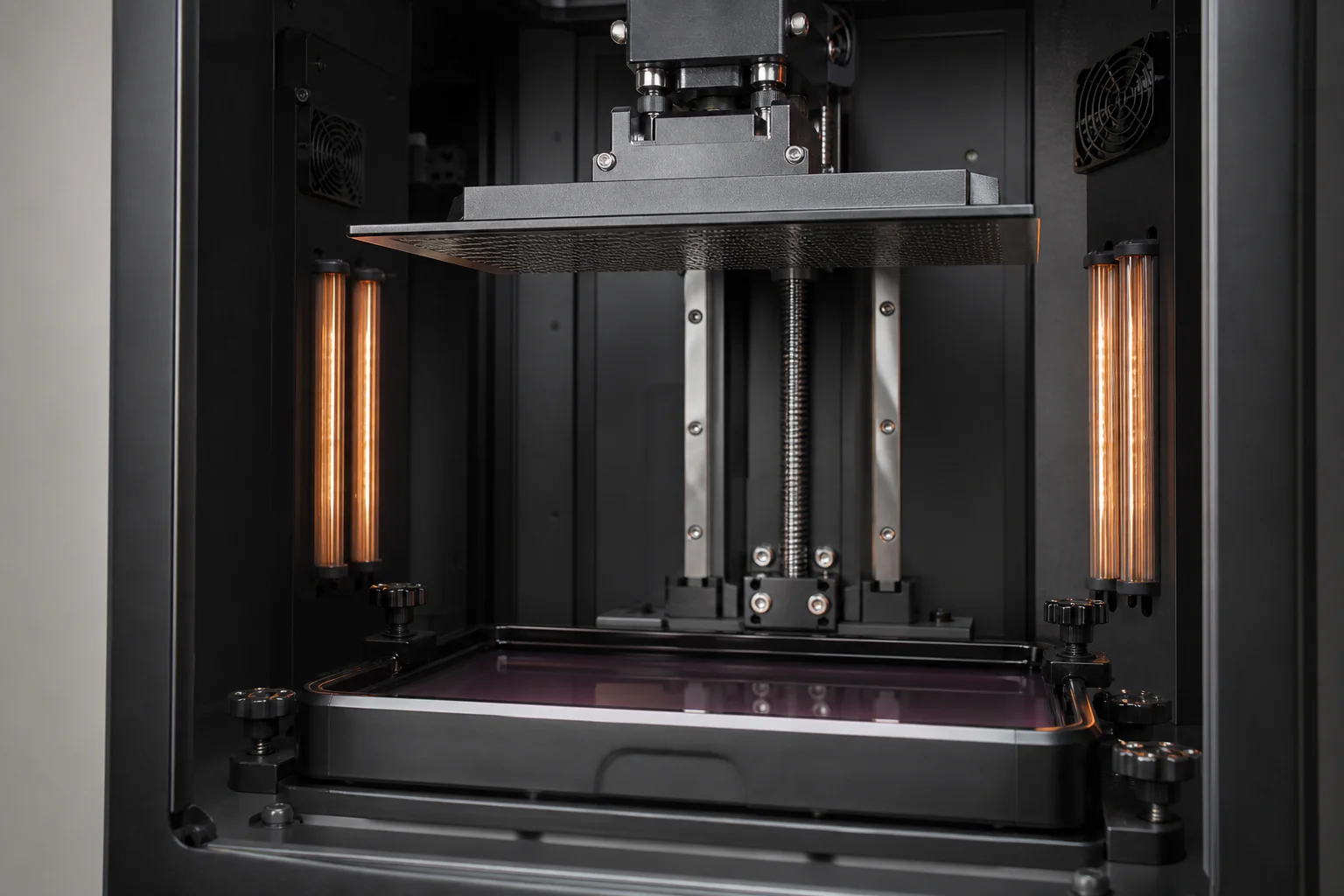 Large-format resin printer interior showing build chamber and heating system