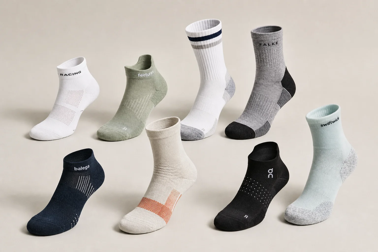 Collection of various running socks in different colors and styles on neutral backdrop