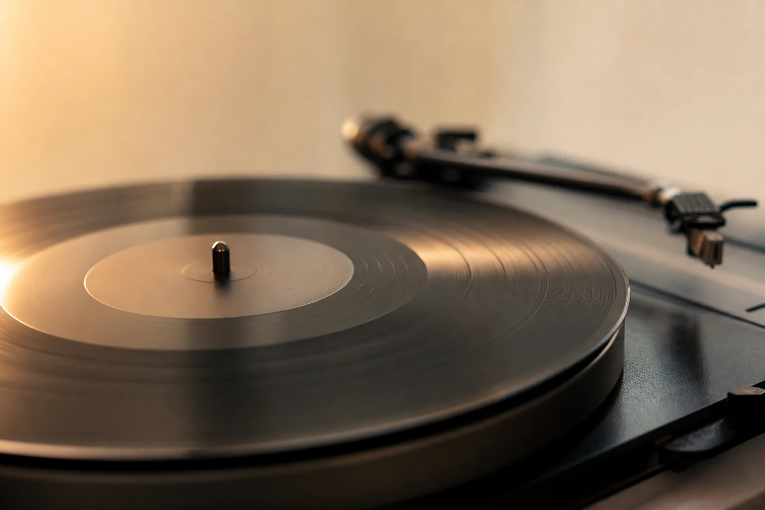 Vinyl record spinning on turntable with warm ambient lighting