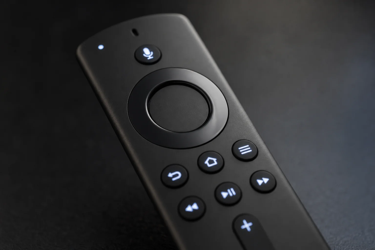 Close-up of streaming device remote with backlit buttons and voice control