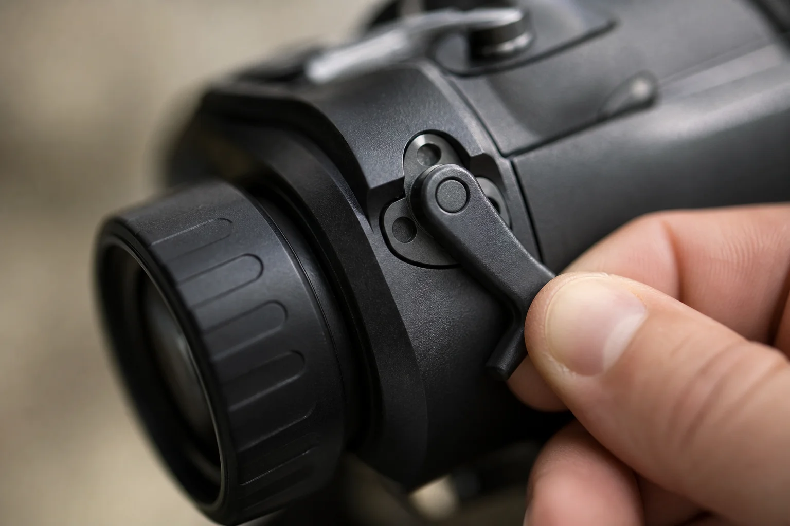 Close-up of dual-lens thermal scope showing manual lens selector lever