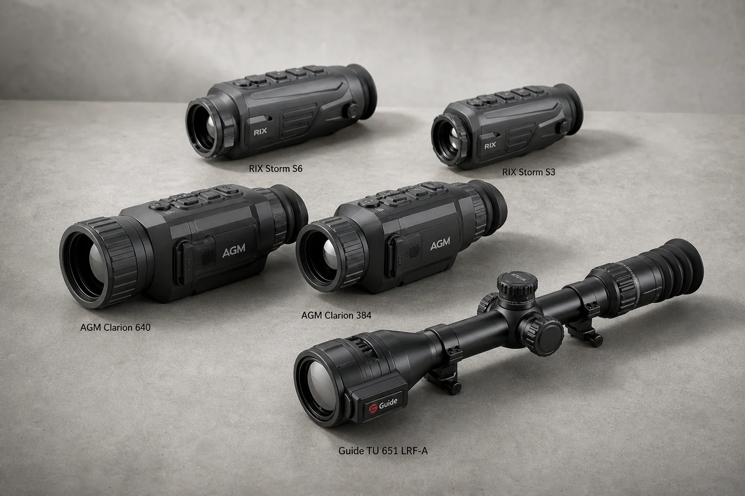 Five thermal imaging scopes displayed on concrete surface