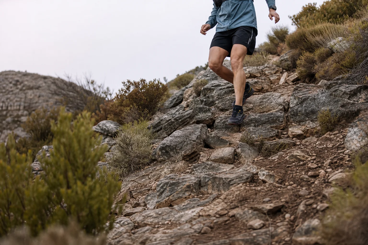 Trail runner navigating technical rocky descent with confident footing