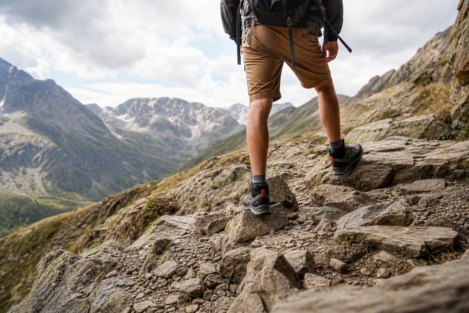 Hiker on mountain trail with stable, supported foot positioning on uneven ground