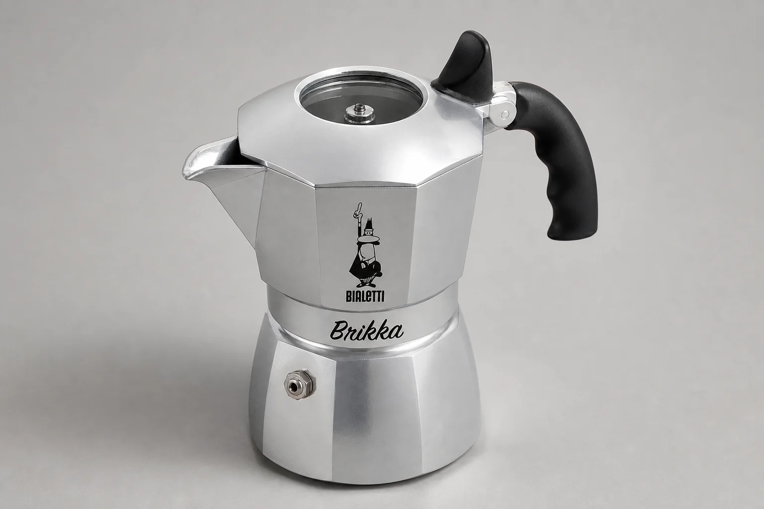 Four moka pot variations displayed on concrete surface