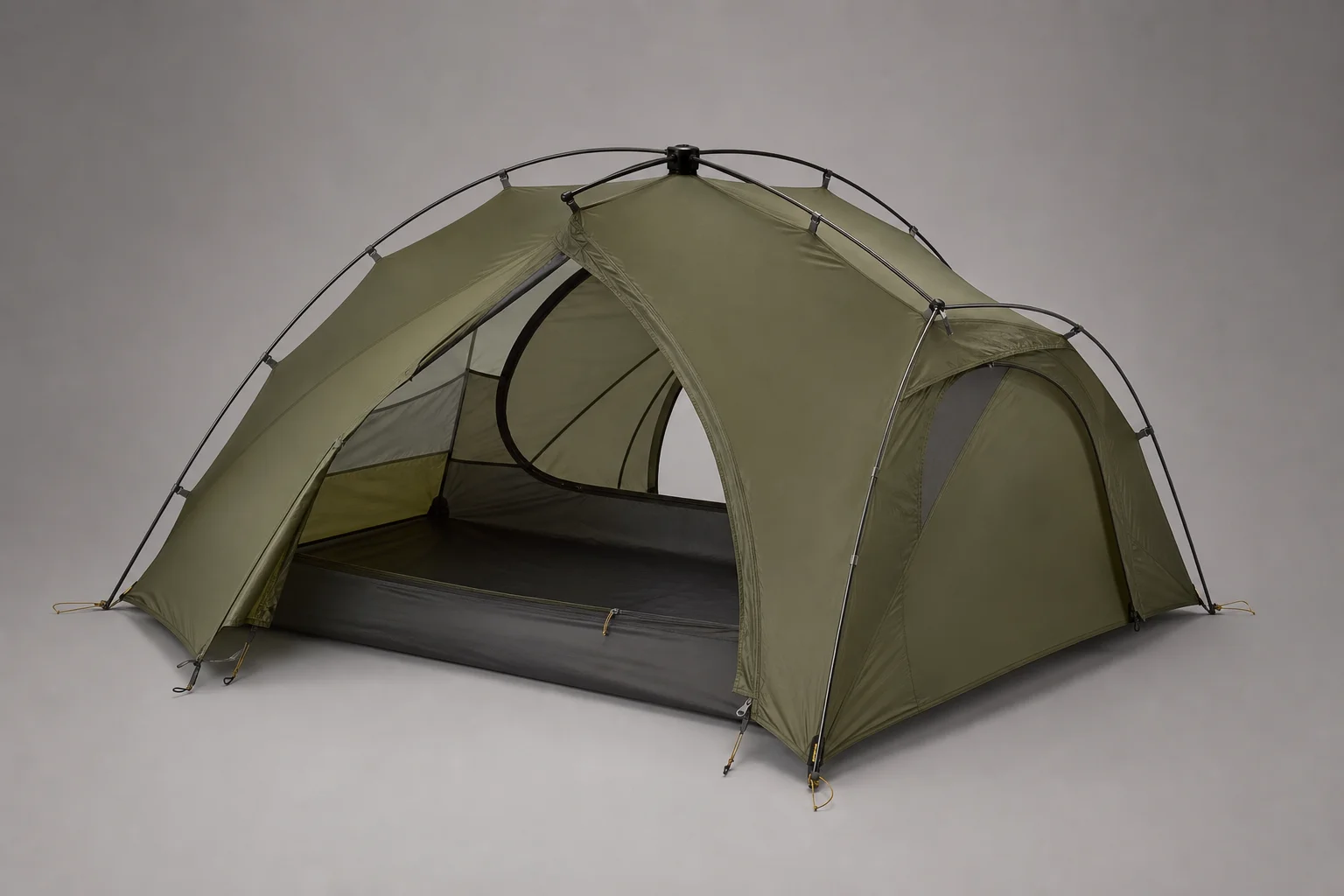 Five ultralight tents displayed on concrete surface showing variety of designs and colors