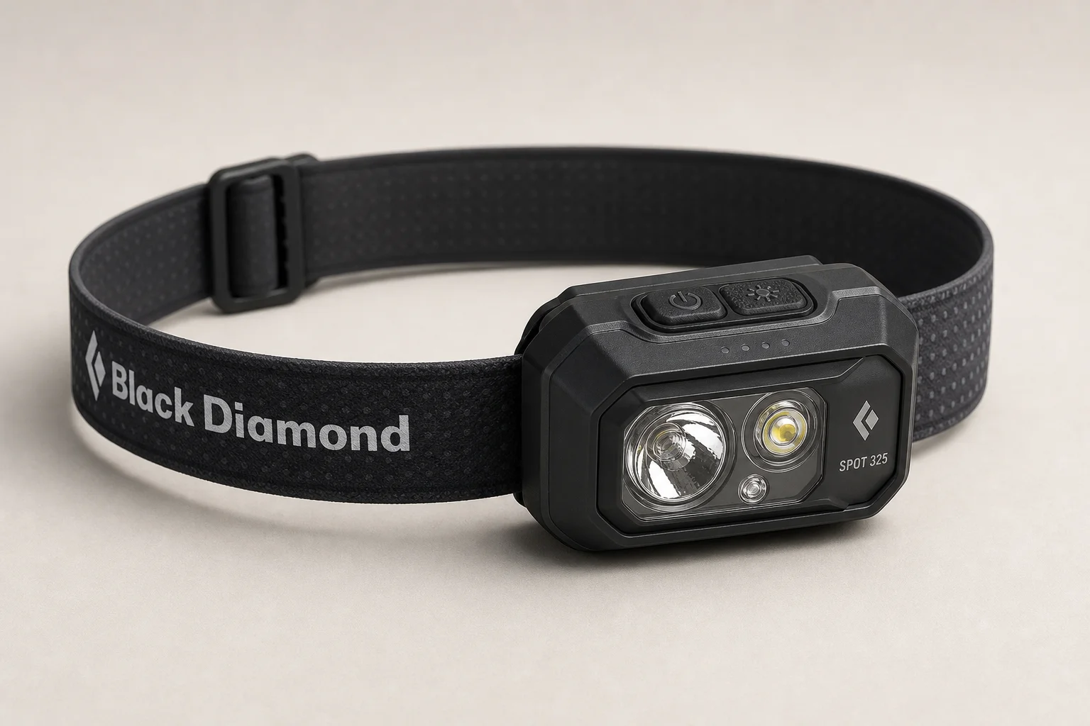 Four headlamps arranged on concrete: Black Diamond Spot 325, Petzl Tikkina, Petzl Actik Core, and BioLite Headlamp 330