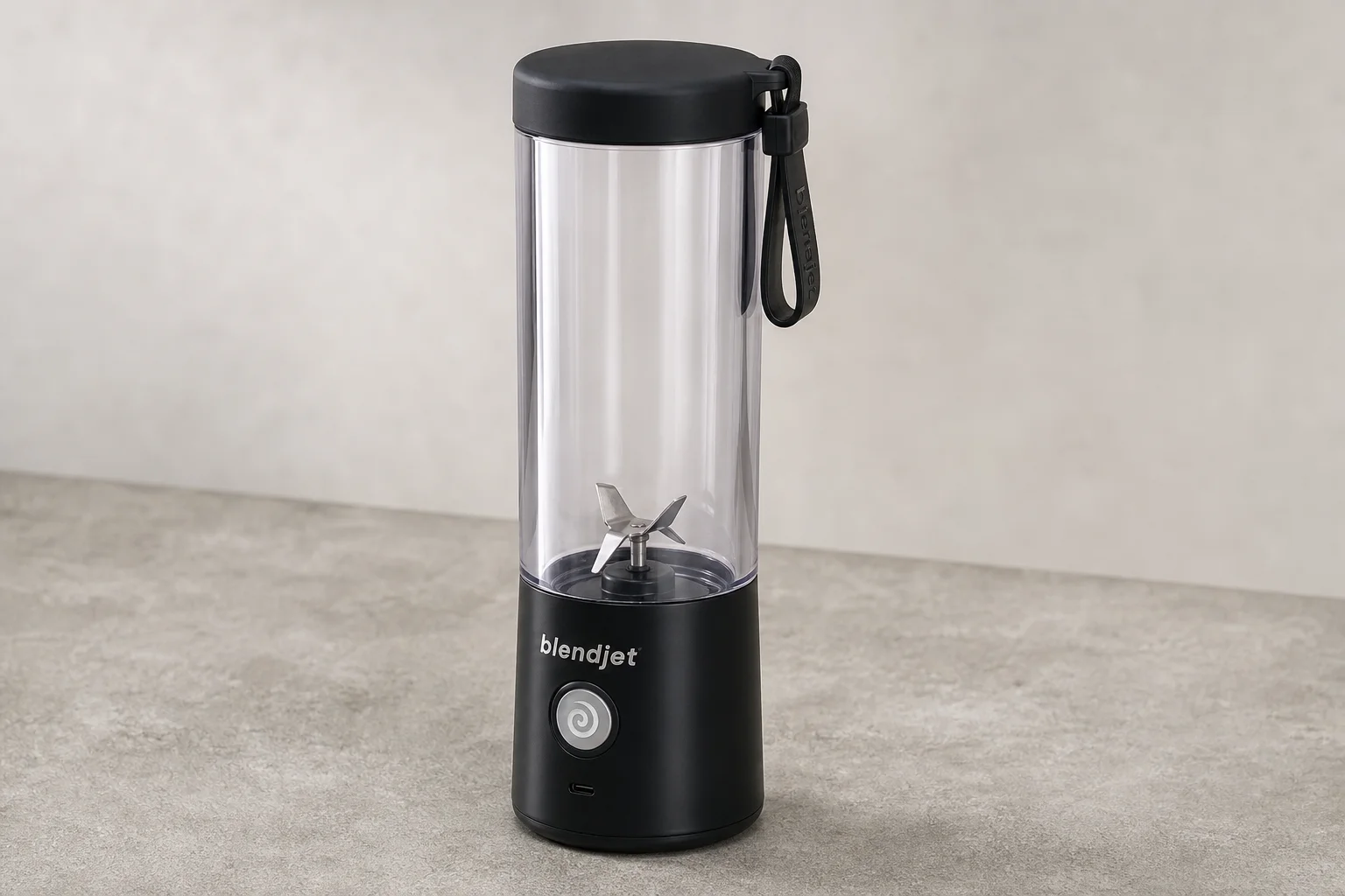 Five cordless blenders arranged on grey concrete surface
