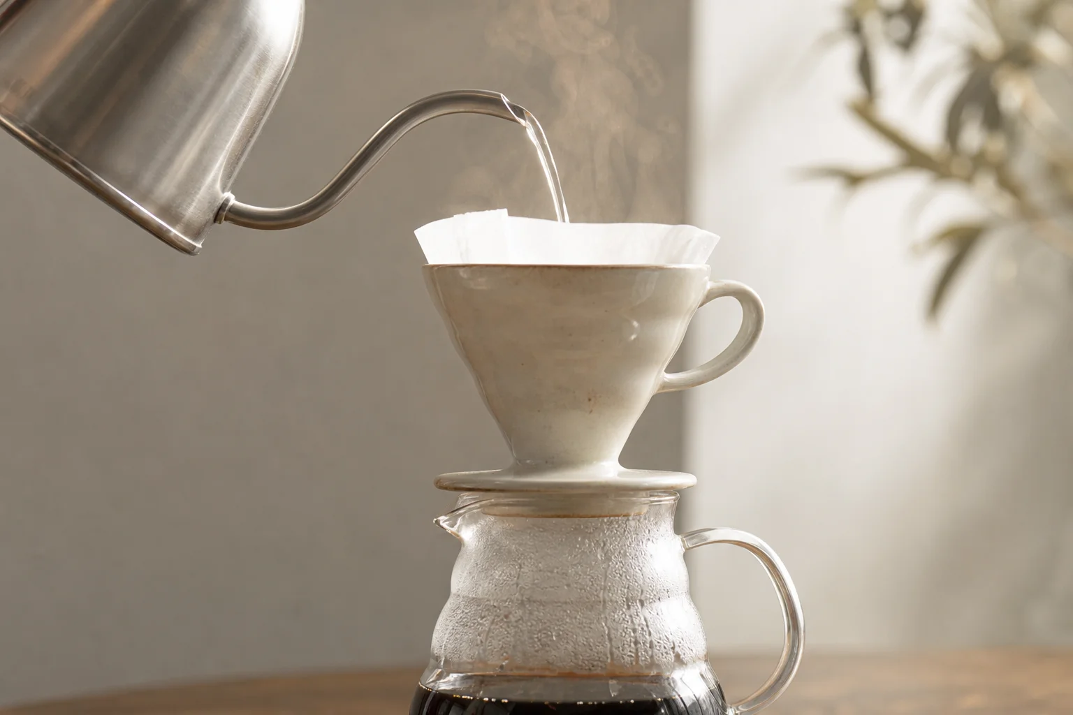 Gooseneck kettle pouring water into a pour-over coffee dripper