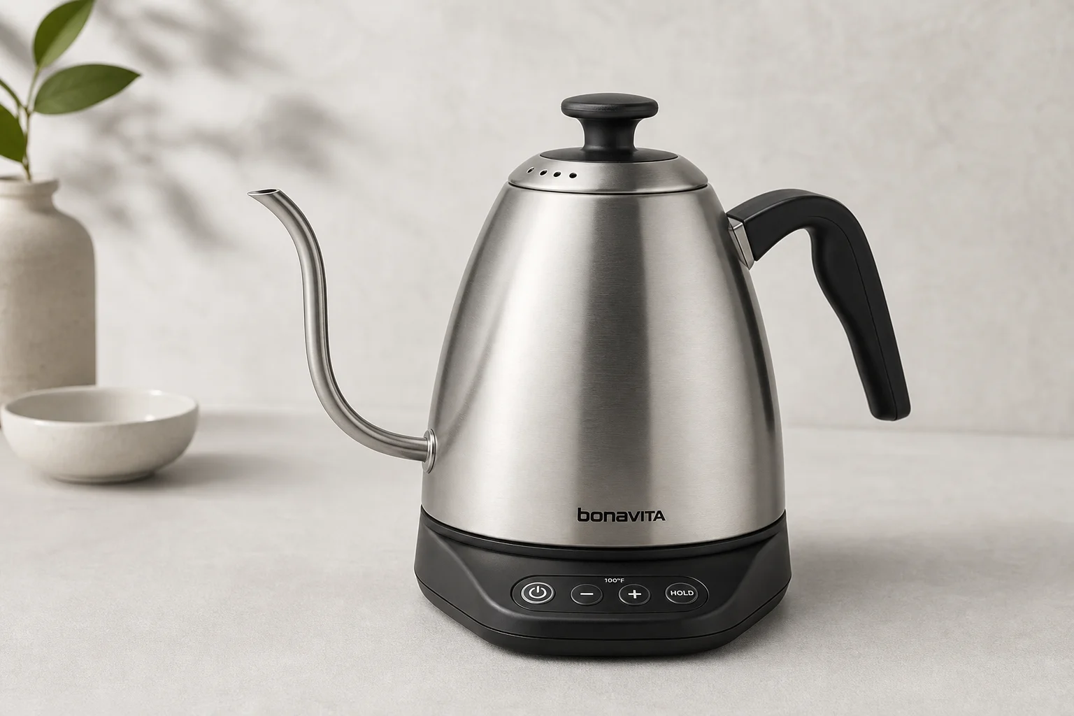 Eight electric gooseneck kettles arranged on concrete surface showing different designs and finishes