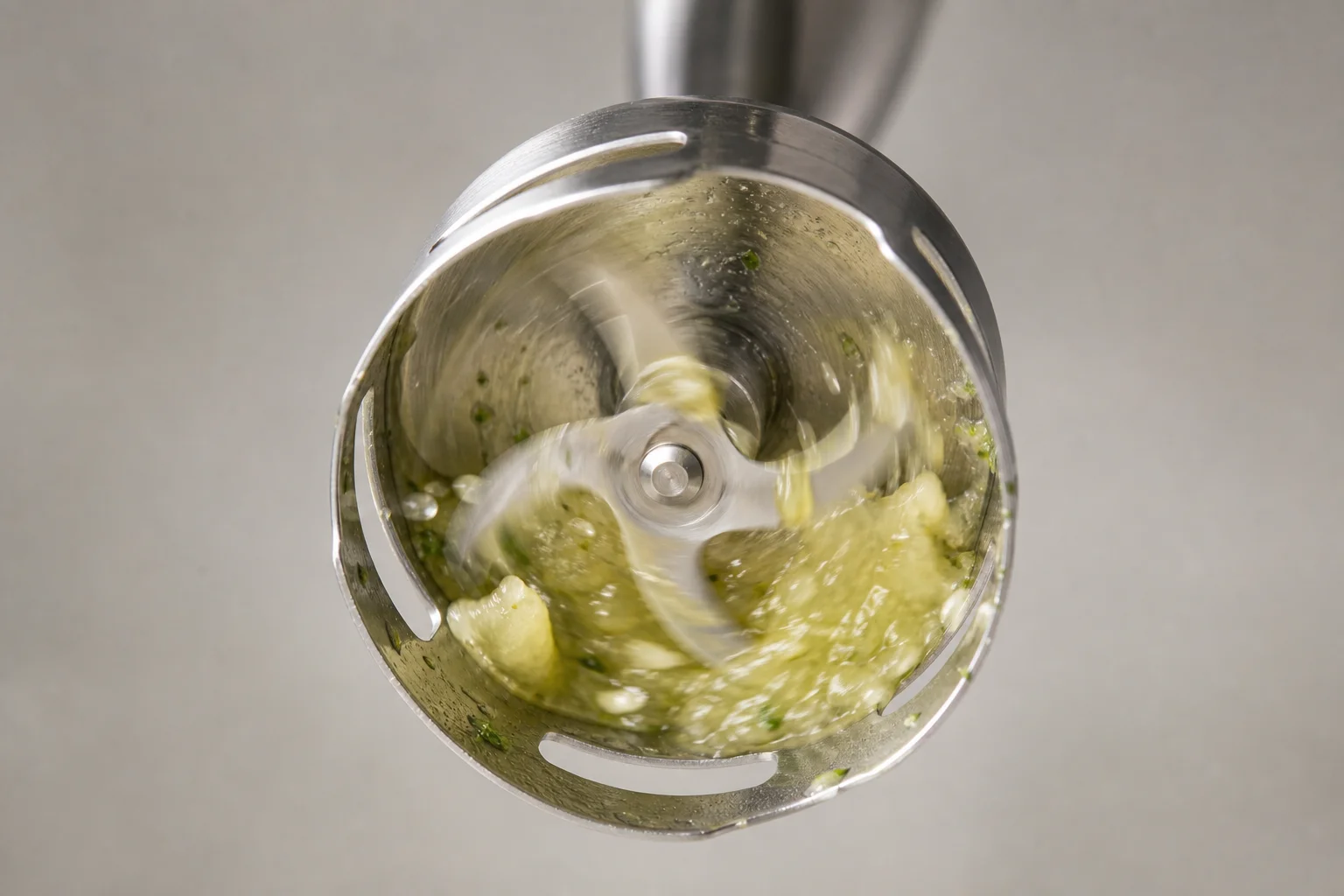 Close-up of hand blender blades during blending action