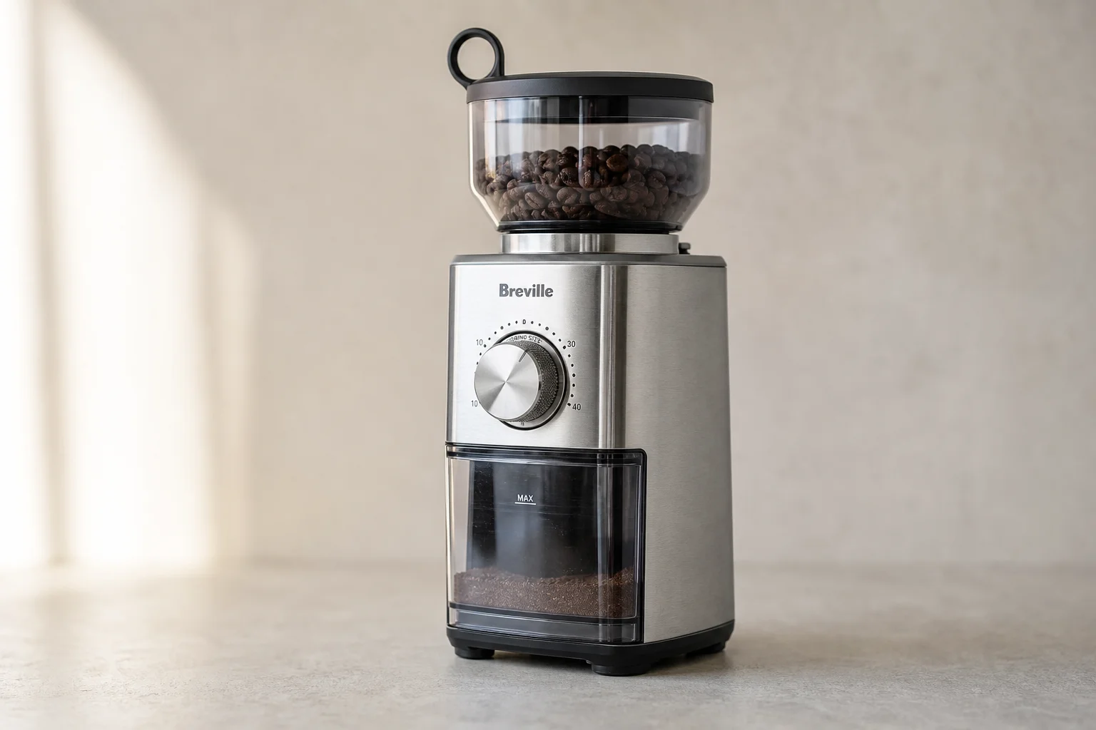 Professional La Marzocco espresso machine next to compact Breville Bambino on neutral background