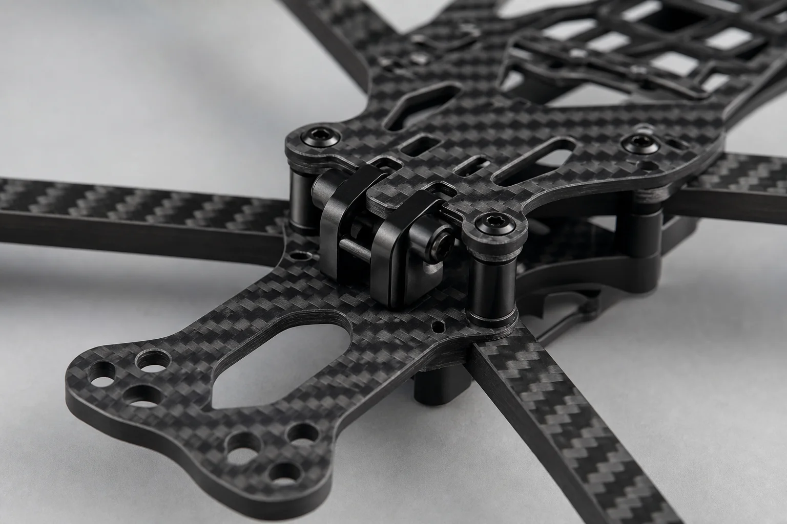 Close-up of carbon fiber drone frame showing structural details and arm design